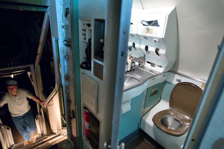 The rear lavatory next to the staircase is one of three aboard the plane, but is the only one currently functioning.