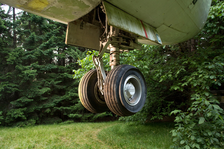 The front landing gear of the airplane hangs above ground.