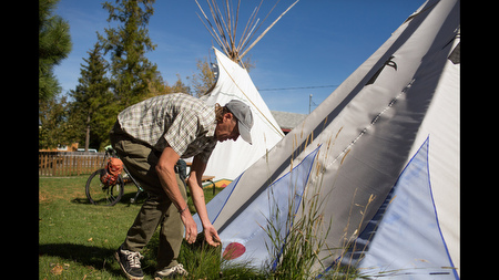 Price helps dismantle a teepee at a Nez Perce Native American photo exhibit in Joseph, where he volunteers the expertise he gained from living in a teepee before building the hobbit hole. 'When we got here in 1865 there wasn't one bucket of concrete anywhere, telephone poles, fences, barbed wire, roads. And yet they had lived here successfully for thousands of years without touching the environment. That was the hugest thing that ever happened in my head. Apparently the hunter gatherer types had all kinds of free time. And so that really impressed upon me - I'm not gonna do what every one else is doing. I'm going to go a whole different direction.'
