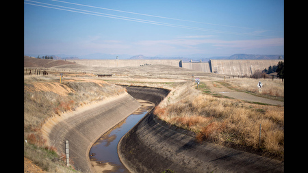 A trace of water sits in the bottom of the Madera Canal, which is fed by the nearby Friant Dam on the San Joaquin River in Friant, Calif.