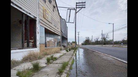 A handful of Picher's commercial buildings remain standing alongside U.S. Route 69. 