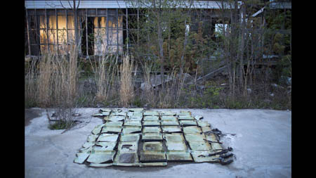 Floor tiles curl up on an empty slab in Picher. 